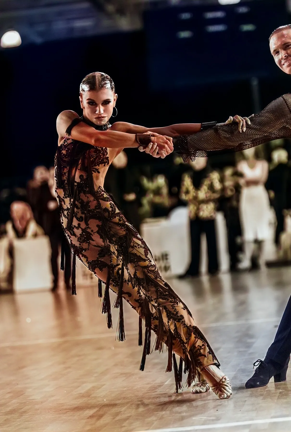 Competitive Latin dancers performing the Cha-Cha